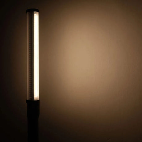 Upright LED stick bicolor light glowing white with long black housing and slim tube