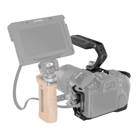 Black camera cage rig on camera with LCD screen mount and side grip attachment