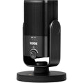 Black USB podcast microphone on desktop stand, with front control dial