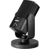 Angled view of black USB podcast microphone with grille, front dial, and base