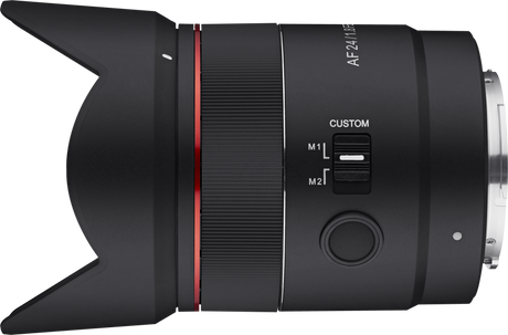 Side view of black AF 24mm f/1.8 FE lens showing custom M1/M2 switch area