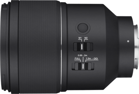 Black camera lens side view with focus mode markings M1/M2 and distance scale