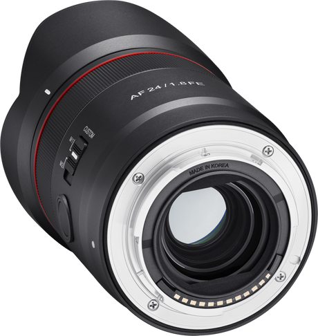 Back view of black AF 24mm f/1.8 FE lens with silver mount contacts and red stripe
