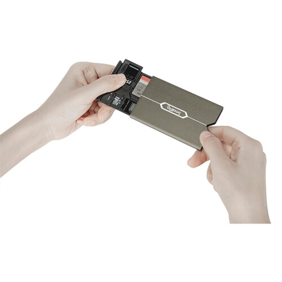 Hands inserting memory cards into open gray case with SD card slots