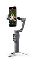 Smartphone gimbal stabilizer with phone clamp and on-tripod base, dark gray