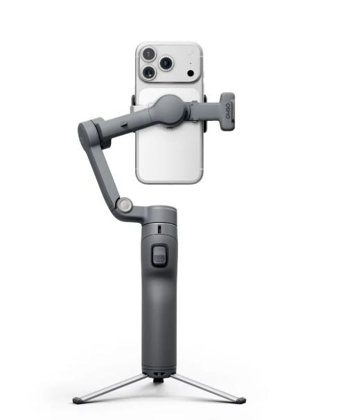 Dark gray gimbal with phone holder showing dual rear cameras, on tripod legs