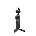 Black handheld gimbal camera with white windscreen, front lens and screen visible