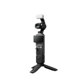 Black handheld gimbal camera with white windscreen, front lens and screen visible