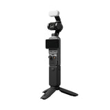 Black gimbal camera with touchscreen display and front lens, white windscreen on top