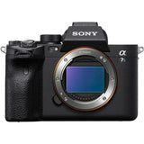 Black mirrorless camera body front view with large lens mount window and dials