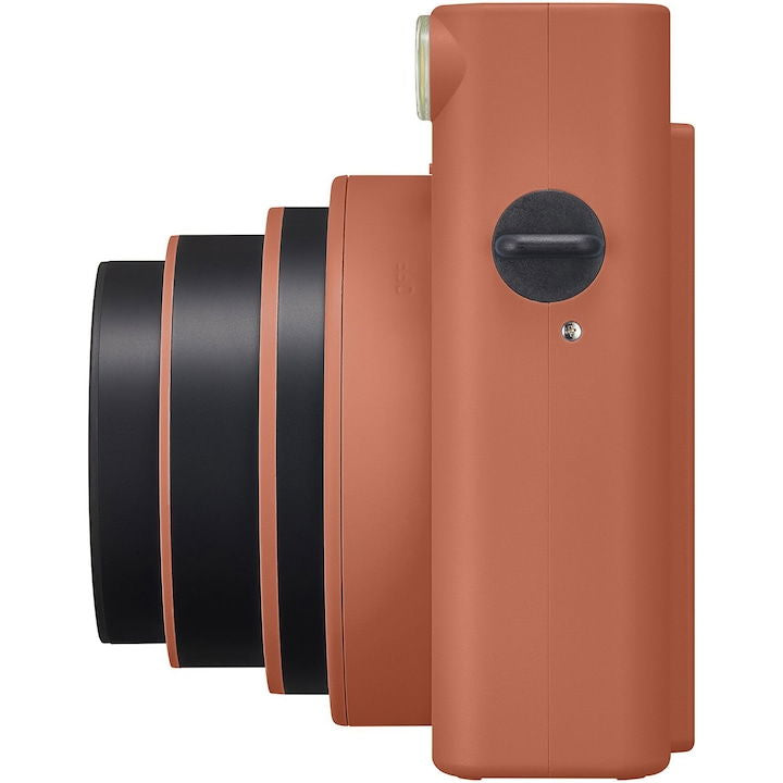 Terracotta orange Instax SQ1 instant camera side view with lens ring and strap loop