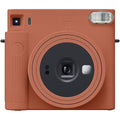 Terracotta orange Instax SQ1 instant camera front with lens and viewfinder window