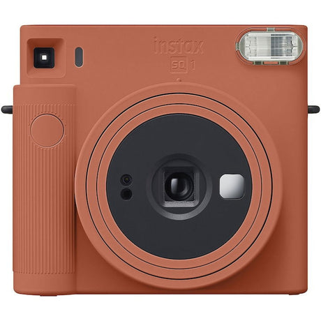 Terracotta orange Instax SQ1 instant camera front with lens and viewfinder window