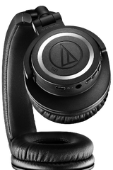 Black over-ear headphones, top view showing earcup controls and side ports