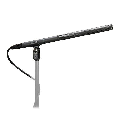 Professional shotgun microphone with mount, black body and grille on a stand