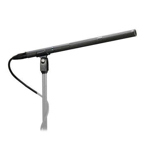 Professional shotgun microphone with mount, black body and grille on a stand
