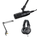 Podcast kit: black microphone with shock mount and boom arm, plus over-ear headphones