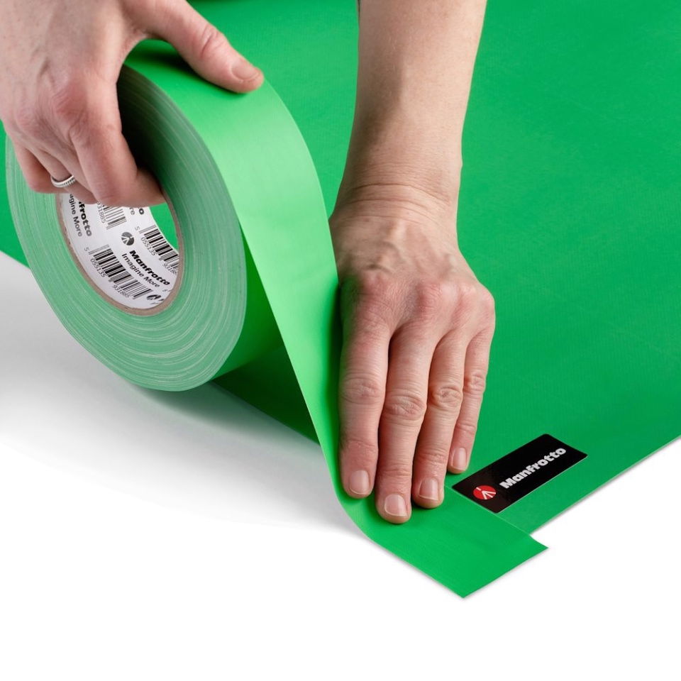 Green chroma key gaffer tape roll unspooling; tape laid down on surface, 50mm x 50m