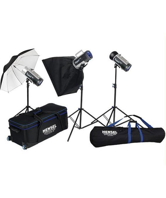 Studio flash lighting kit with three heads, softboxes, light stands, and carry cases