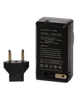 Back of black travel charger with two-pin plug and battery compartment
