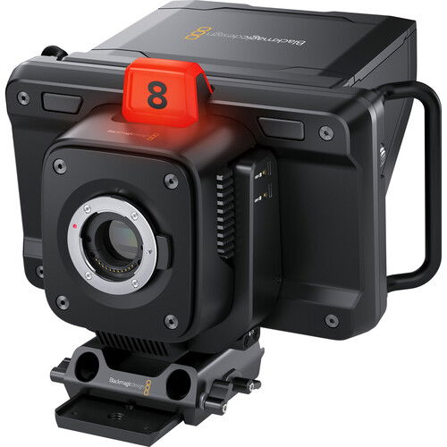 Angled studio camera side view with red tally light, lens housing and vented body
