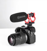 Shotgun mic on camera with red shock mount and round foam windscreen