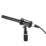 Black shotgun microphone mounted on stand with shock mount and connected cable