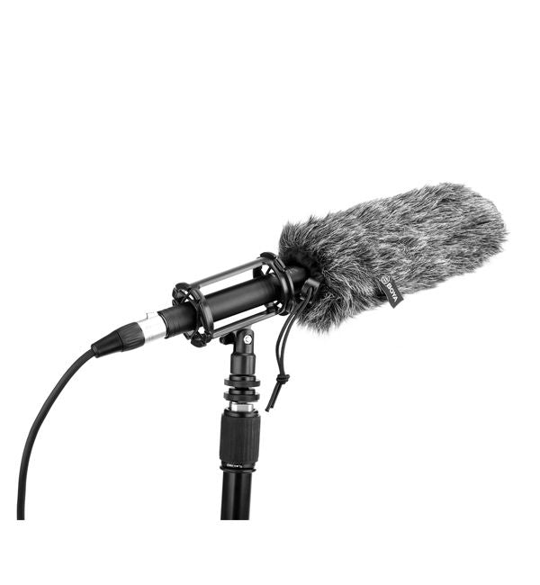 Shotgun microphone with gray furry windscreen mounted in a shock mount