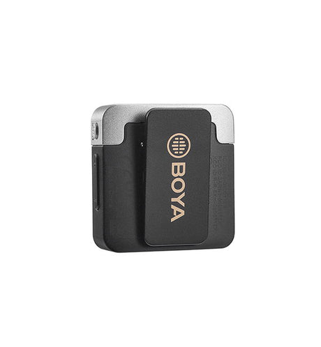 Wireless lavalier mic unit close-up, black body with circular grille logo and silver top