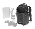 Black photo backpack with front compartments, top handle, and adjustable shoulder straps