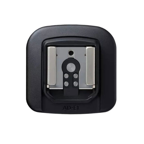 AD-E1 shoe adapter base with metal contacts visible in open cradle
