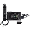 Black compact digital camera with grip, lens, USB connector, and cables