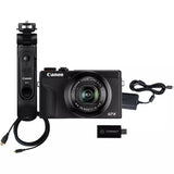 Black compact digital camera with grip, lens, USB connector, and cables