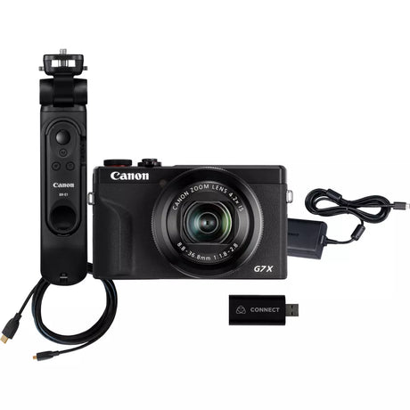 Black compact digital camera with grip, lens, USB connector, and cables