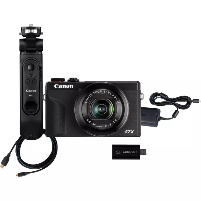 Black compact digital camera with grip, lens, USB connector, and cables