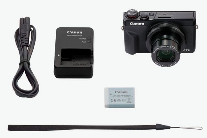 Compact camera bundle: charger, battery, USB cable, and wrist strap with camera