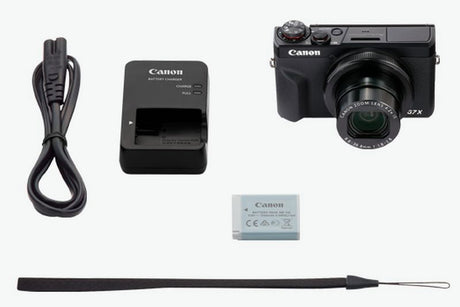 Camera kit accessories: charger, extra battery, cable, and wrist strap