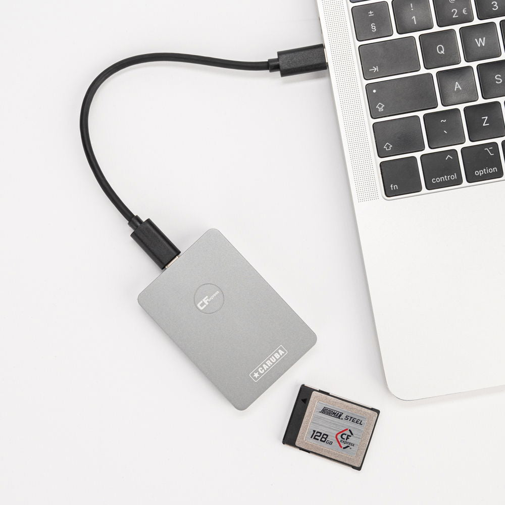 Gray CFexpress Type B card reader with USB cable and CFexpress card nearby