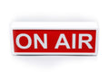 ON AIR light box sign with bold white letters on red panel, in white casing.