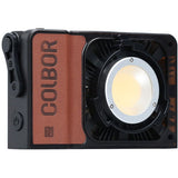 Portable 100W LED RGB light with front circular lens and housing vented sides