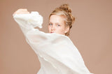 Coffee brown photo backdrop seamless background with model in white, arms raised