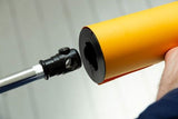 Black background brake/clamp attached to orange roll near stand