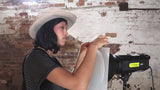 Translucent white backdrop panel held for studio photos near a light