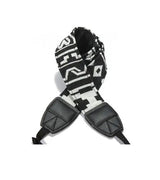 Camera strap detail with black/white patterned fabric and two black leather end pads