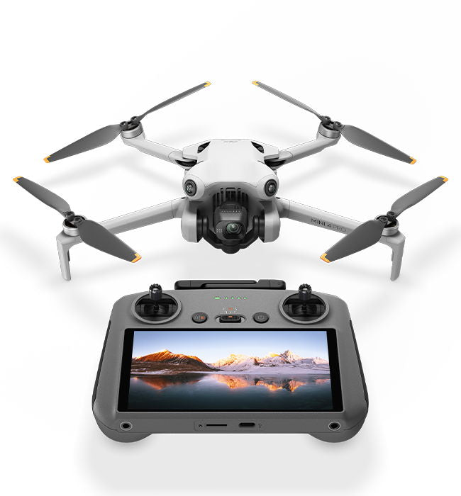 White quadcopter drone with 4 foldable propellers and black remote controller with screen