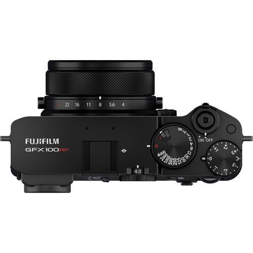 Aparat foto compact negru din lateral cu cadran de control și partea superioară