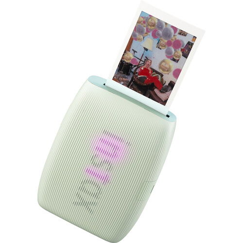 Green instant photo printer with printed photo on top