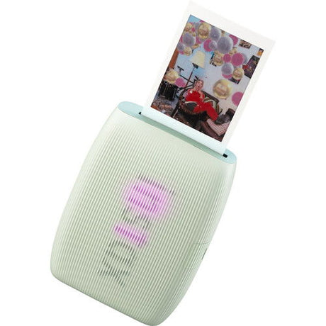 Green instant photo printer with printed photo on top