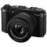 Black mirrorless camera with lens, angled front and top controls