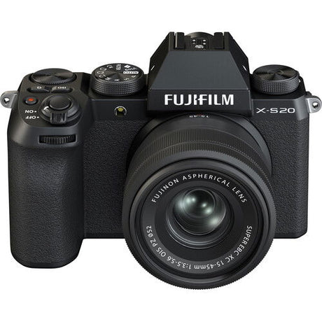 Black mirrorless camera with 15-45mm lens, front-right view, top dials visible